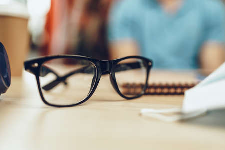 Glasses and medical mask on the tableの写真素材