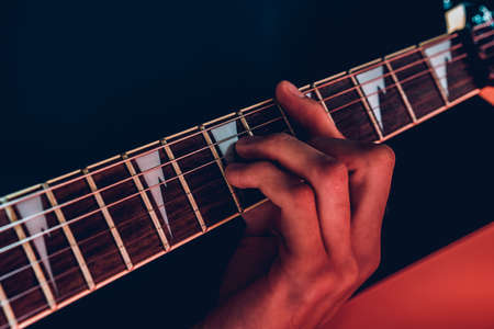 Close up photo of male hands playing guitarの写真素材