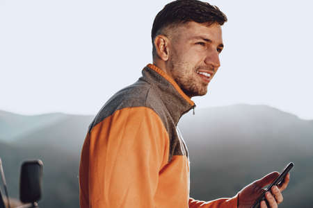 Young caucasian man traveller using his smartphoneの写真素材