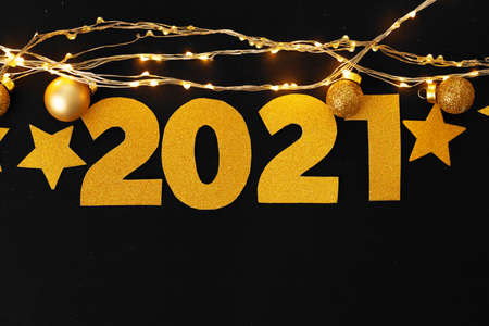 Concept of the year 2021. Golden stars with 2021 numbers on paper background