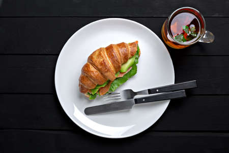 Sandwich croissant in plate for breakfast close upの写真素材