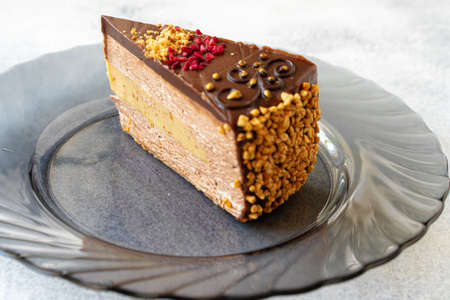 Piece of chocolate cheesecake with nuts close up