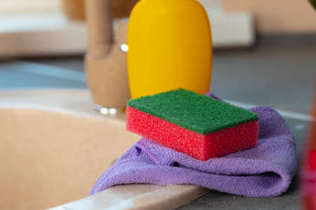 Cleaning sponge and rag on kitchen counterの写真素材