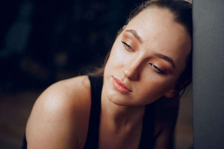 Brunette young woman sitting tired in a gym after workoutの写真素材