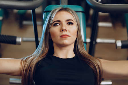 Young blonde woman fitness coach doing hands workoutの写真素材