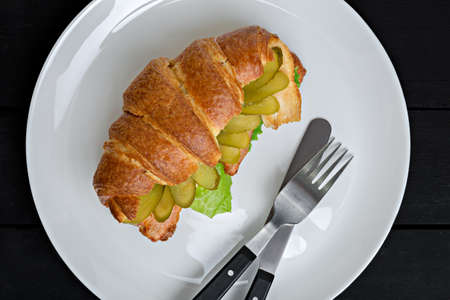 Sandwich croissant in plate for breakfast close upの写真素材