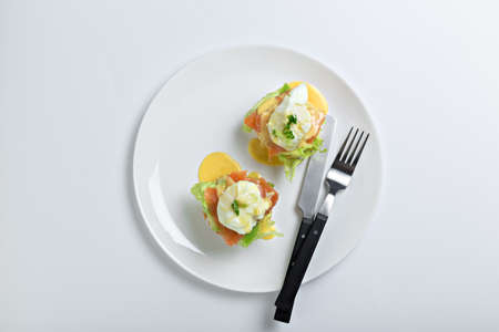 Top view of toasted buns with bacon, lettuce and poached eggの写真素材