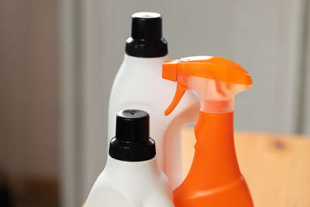 Cleaning detergents and tools on a kitchen counter