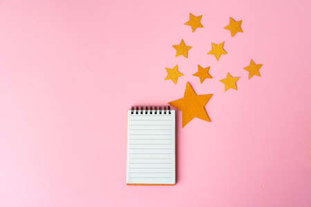 Blank sheet of paper with golden decorative stars. New year resolutions conceptの写真素材