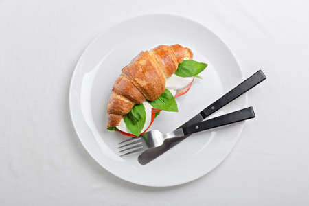 Sandwich croissant in plate for breakfast close upの写真素材