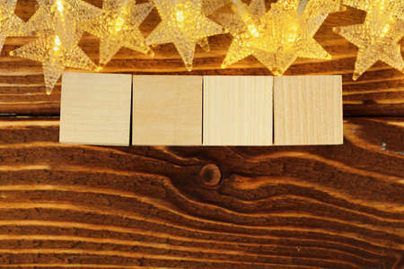Four wooden blocks with deocrative stars. New Year conceptの写真素材