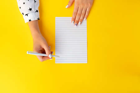 To do list. Top view of female hands writing in notebookの写真素材