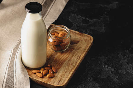Almond milk with almond nuts in glassの写真素材