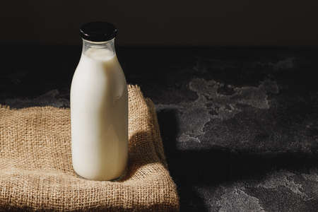 Closed blank glass bottle of milk, front viewの写真素材