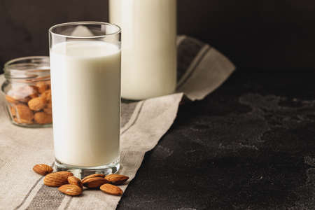 Almond milk with almond nuts in glassの写真素材