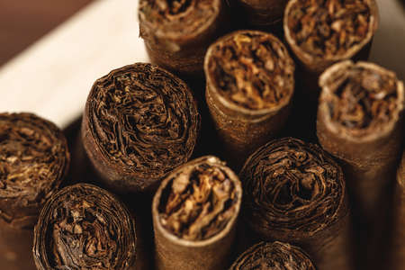 Pile of new cigars close up on wooden table