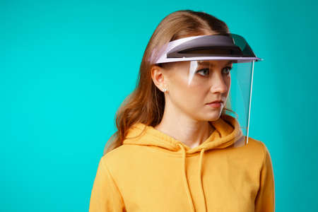 Young woman wearing medical protective face shield