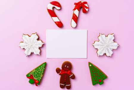 Mock up of holiday greeting card with gingerbread cookies on pink background