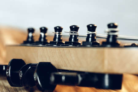 Guitar headstock with tuners on dark backgroundの写真素材