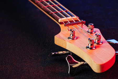 Guitar headstock with tuners on dark backgroundの写真素材