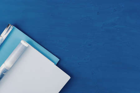 Top view of open magazine page with copy space on classic blue background