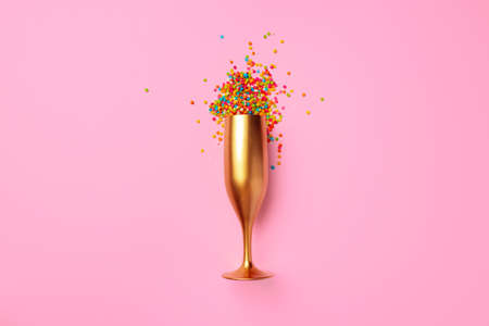 Champagne glass with confetti flat lay top viewの写真素材