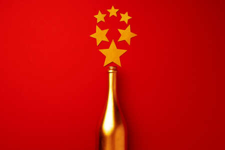 Festive background with champagne bottle and confettiの写真素材