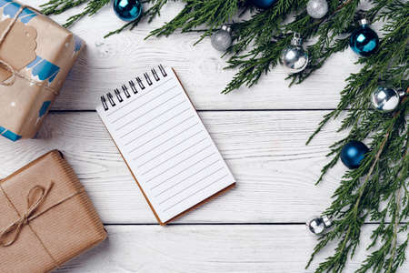 White wooden background with coniferous branches and Christmas decorationsの写真素材