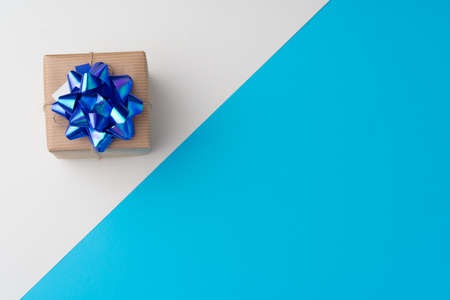 Top view of gift box with ribbon on blue backgroundの写真素材