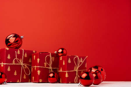 Christmas gift boxes against red background front viewの写真素材