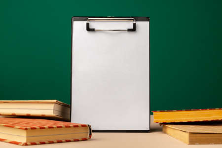 Blank clipboard with copy space and school supplies