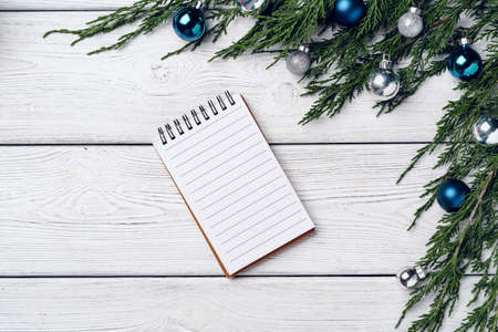 White wooden background with coniferous branches and Christmas decorationsの写真素材