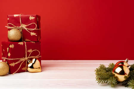 Christmas gift boxes against red background front viewの写真素材