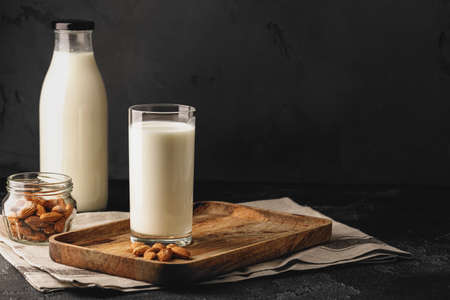 Almond milk with almond nuts in glassの写真素材