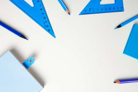 School accessories on blue and white background top viewの写真素材