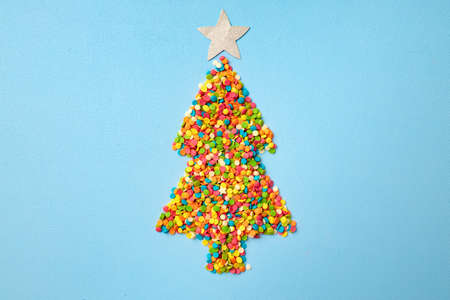 Christmas tree made of colorful confetti flat lay