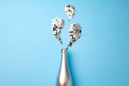Festive background with champagne bottle and confettiの写真素材