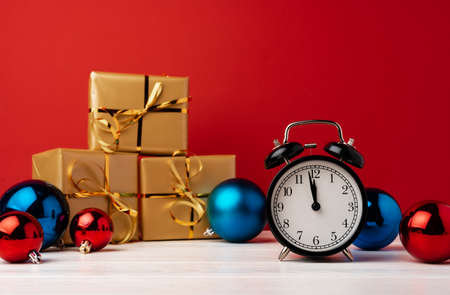 Christmas and New Year countdown concept with alarm clock