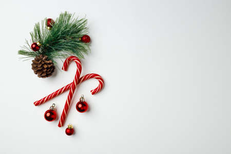 Candy canes and red Christmas baubles on whiteの写真素材