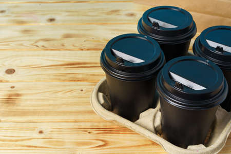 Black take away coffee cups in holderの写真素材