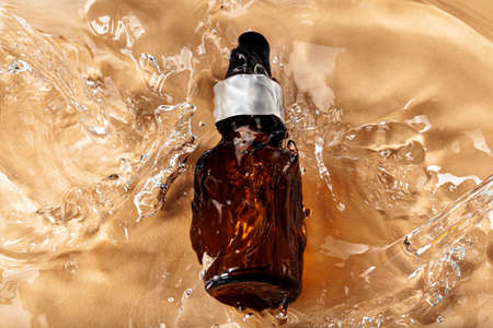 Oil cosmetic bottle on water waves backgroundの写真素材