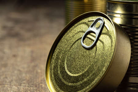 Tin cans with food on the table.
