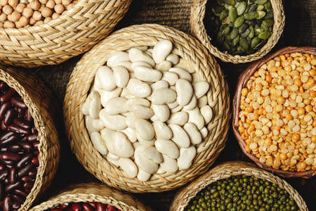 Assortment of beans on wooden background. Close up.