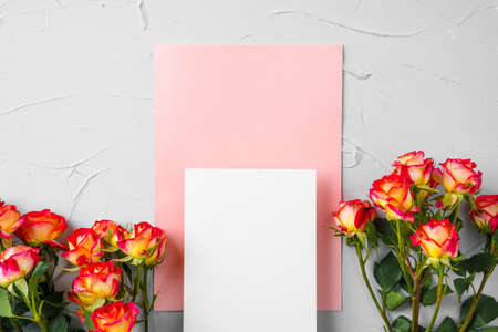 Top view of a pink paper letter and flowers with copy space