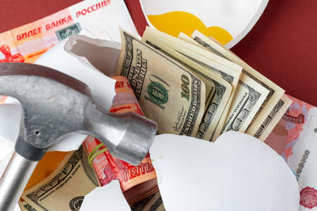 Multicurrency basket concept. Piggy bank with banknotes of US dollars and russian roubles