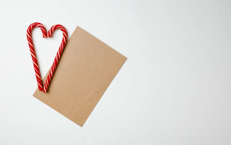 Christmas card and candy canes on white backgroundの写真素材