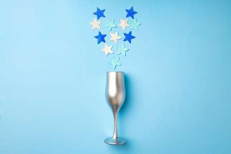 Champagne glass with confetti flat lay top view