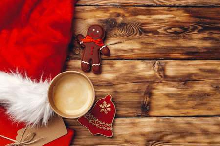 Santa Claus cap and Christmas gift on wooden background top viewの写真素材