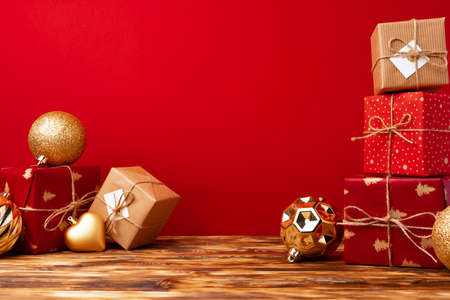 Christmas gift boxes against red background front viewの写真素材