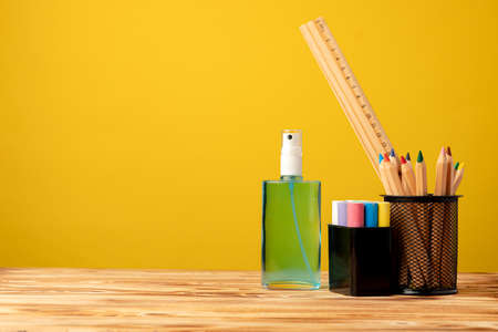 School stationery and hand sanitizer. Back to school concept while coronavirus pandemic
